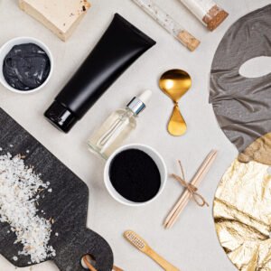 Flat lay of cosmetic products on the basis of activated charcoal, top view. Beauty and natural skin care concept. Branding mock up